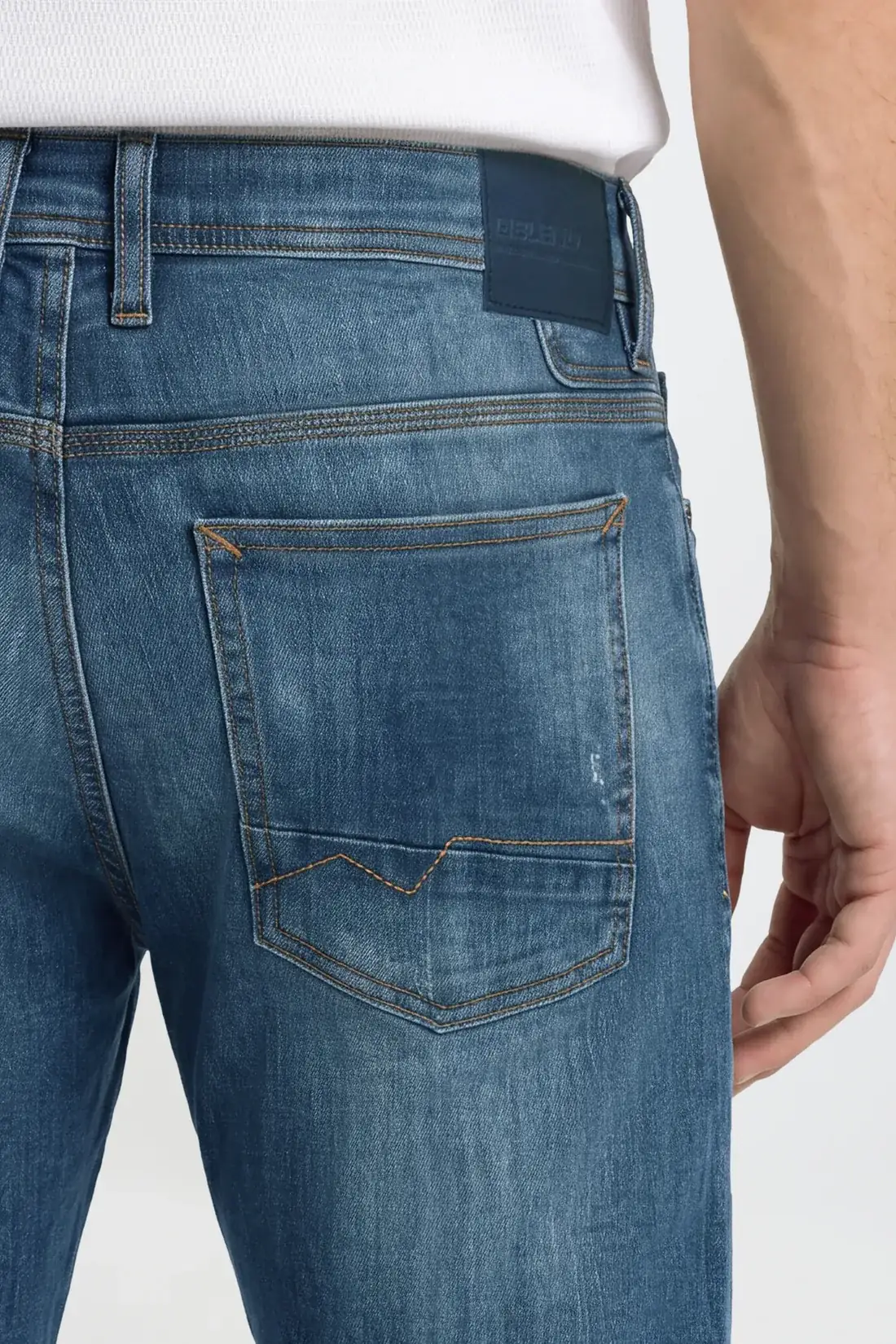 Corrected back pocket with restored arcuate stitching and leather patch