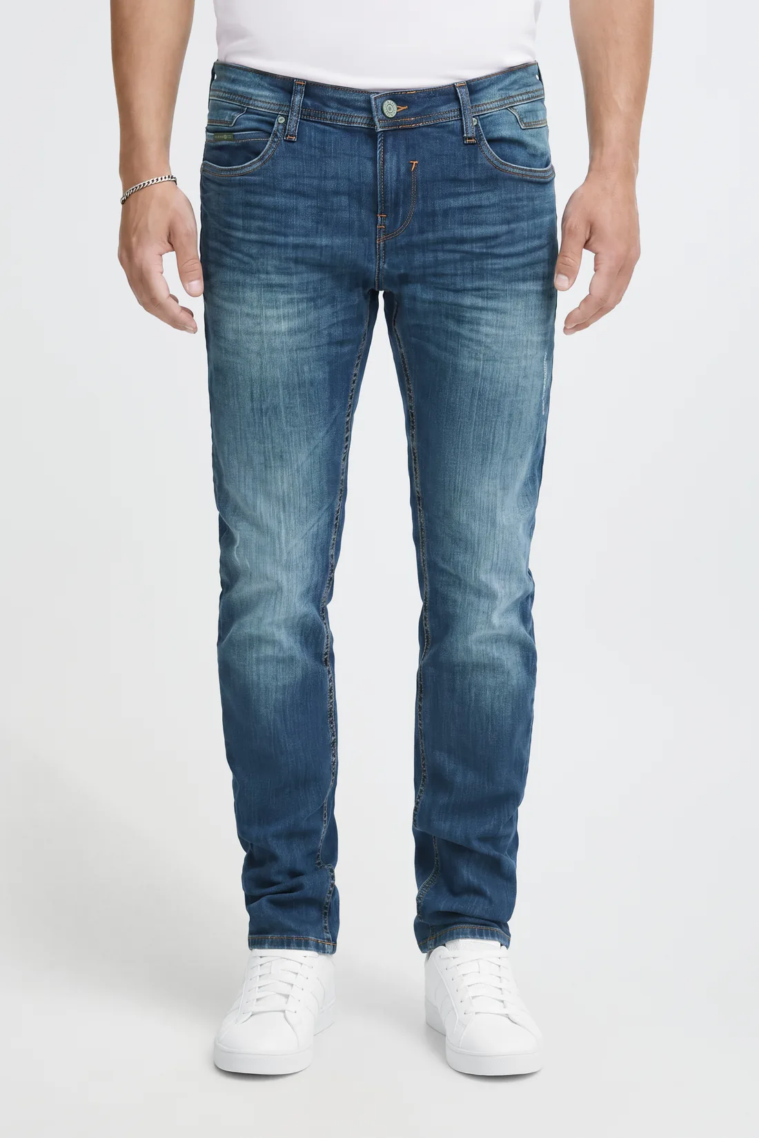 The same frame after hand correction, with the true denim wash restored